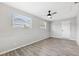 Cozy bedroom featuring neutral tones, two large windows, and sleek flooring, perfect for a relaxing retreat at 7891 67Th N St, Pinellas Park, FL 33781