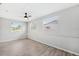 Bright bedroom with three windows, ceiling fan, and durable wood-look flooring at 7891 67Th N St, Pinellas Park, FL 33781