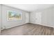 Comfortable bedroom with neutral walls, wood-look flooring, and a large window, creating a serene living space at 7891 67Th N St, Pinellas Park, FL 33781