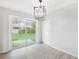 Dining area with sliding glass door, modern lighting, and wood-look floors at 7891 67Th N St, Pinellas Park, FL 33781