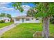 Home exterior showcasing a lush front yard and driveway at 7891 67Th N St, Pinellas Park, FL 33781