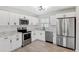 Modern kitchen featuring stainless steel appliances, white cabinets, subway tile backsplash, and sleek black hardware at 7891 67Th N St, Pinellas Park, FL 33781