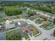 A beautiful aerial view showcases a lakeside community with a mix of screened in patios and homes with blue driveways at 8110 Damara Dr, New Port Richey, FL 34653