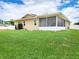 Backyard with a spacious screened in porch, green grass, and well maintained siding at 8110 Damara Dr, New Port Richey, FL 34653