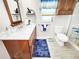 Bathroom featuring a marble countertop vanity, white toilet, and glass shower at 8110 Damara Dr, New Port Richey, FL 34653