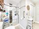 Bathroom showcases a spacious glass shower with safety features and storage shelves at 8110 Damara Dr, New Port Richey, FL 34653