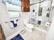 Bathroom boasts a glass door shower, white toilet, and wood-look tile flooring at 8110 Damara Dr, New Port Richey, FL 34653
