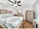 Bedroom featuring a ceiling fan, wood floors, neutral paint, and ample closet space at 8110 Damara Dr, New Port Richey, FL 34653