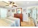 Bedroom featuring wood floors, a dresser, a mirror, and a view to the living room at 8110 Damara Dr, New Port Richey, FL 34653