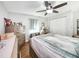 Bedroom featuring a ceiling fan, wood floors, neutral paint, and ample closet space at 8110 Damara Dr, New Port Richey, FL 34653