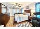 Bright bedroom with wood floors features a ceiling fan, a full-size bed, and a dresser at 8110 Damara Dr, New Port Richey, FL 34653