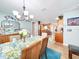 Bright dining room with chandelier and view into kitchen at 8110 Damara Dr, New Port Richey, FL 34653