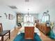 Elegant dining room featuring a wooden table, wood floors and light blue walls at 8110 Damara Dr, New Port Richey, FL 34653