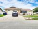 Charming single-story home featuring a well-manicured lawn and an attached two car garage at 8110 Damara Dr, New Port Richey, FL 34653