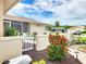 Home featuring a beautifully landscaped front yard with colorful flowers, white picket fence and stone walkway at 8110 Damara Dr, New Port Richey, FL 34653