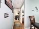 Hallway with wood floors leads to bedroom and laundry, with chair on the right at 8110 Damara Dr, New Port Richey, FL 34653