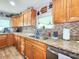 Modern kitchen featuring wood cabinets, granite countertops, and stainless steel appliances at 8110 Damara Dr, New Port Richey, FL 34653