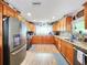 Well-equipped kitchen with granite countertops, stainless steel appliances, and hardwood floors at 8110 Damara Dr, New Port Richey, FL 34653