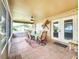 Enclosed lanai featuring outdoor seating and dining area with tile flooring for comfortable outdoor living at 8110 Damara Dr, New Port Richey, FL 34653