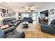 Comfortable living room with hardwood floors, a ceiling fan, and a decorative fireplace at 8110 Damara Dr, New Port Richey, FL 34653