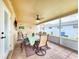 Charming enclosed patio featuring decorative accents, a ceiling fan, and comfortable outdoor furniture, perfect for unwinding at 8110 Damara Dr, New Port Richey, FL 34653