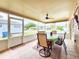 Enclosed patio with tile flooring, ceiling fan, and outdoor furniture, ideal for relaxation and entertaining at 8110 Damara Dr, New Port Richey, FL 34653