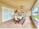 Relaxing enclosed patio with decorative lighting, a ceiling fan, and outdoor seating, offering a comfortable retreat at 8110 Damara Dr, New Port Richey, FL 34653