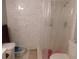 Bathroom with modern white tiled shower and updated fixtures at 9100 Dr Martin Luther King Jr N St # 303, St Petersburg, FL 33702