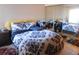 This is a bedroom with a patterned bed cover, mirrored closet doors, and an area rug at 9100 Dr Martin Luther King Jr N St # 303, St Petersburg, FL 33702