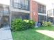 This is an exterior view of a 2-story condo with a patio and a green lawn at 9100 Dr Martin Luther King Jr N St # 303, St Petersburg, FL 33702