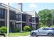 Exterior view of a two-story condominium building with screened patios at 9100 Dr Martin Luther King Jr N St # 303, St Petersburg, FL 33702