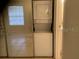 Bright laundry area featuring a stackable washer and dryer near a window, offering convenience and efficiency at 9100 Dr Martin Luther King Jr N St # 303, St Petersburg, FL 33702