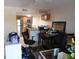 Open concept living room and kitchen area featuring stainless steel appliances and hardwood cabinets at 9100 Dr Martin Luther King Jr N St # 303, St Petersburg, FL 33702