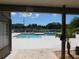 Community swimming pool with a spacious deck, sunny skies, and lush greenery at 9100 Dr Martin Luther King Jr N St # 303, St Petersburg, FL 33702