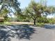 Tennis court and parking lot surrounded by mature landscaping and trees at 9100 Dr Martin Luther King Jr N St # 303, St Petersburg, FL 33702