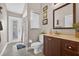 Functional bathroom with a vanity, toilet, shower and access to outdoors, offering convenience and practicality at 9220 Hidden Water Cir, Riverview, FL 33578