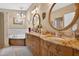 Bathroom with double sink vanity, granite counters, and soaker tub at 9220 Hidden Water Cir, Riverview, FL 33578