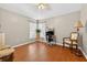 Bright, multipurpose bedroom featuring hardwood floors, a desk, and a ceiling fan, ideal for work or relaxation at 9220 Hidden Water Cir, Riverview, FL 33578