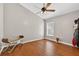 Minimalist bedroom with hardwood floors, a bench, and soft natural light, perfect for a peaceful retreat at 9220 Hidden Water Cir, Riverview, FL 33578