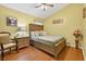 Cozy bedroom with a comfortable bed, wood floors, and soft lighting, creating a relaxing atmosphere at 9220 Hidden Water Cir, Riverview, FL 33578