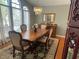 Well-lit dining room with hardwood floors, chandelier, and a view of the window at 9220 Hidden Water Cir, Riverview, FL 33578