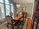 Dining room featuring chandelier, large window, and a wood table with seating for four at 9220 Hidden Water Cir, Riverview, FL 33578