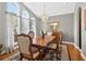 Elegant dining room with classic wood table and chairs, complemented by a stylish chandelier and large windows at 9220 Hidden Water Cir, Riverview, FL 33578