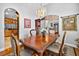 Elegant dining room featuring classic wood table and chairs and complemented by a stylish chandelier at 9220 Hidden Water Cir, Riverview, FL 33578