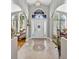 Grand foyer with high ceilings, tile flooring, ornate front door, and a view to other rooms at 9220 Hidden Water Cir, Riverview, FL 33578