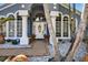 Inviting front entrance featuring decorative pots, white columns, brick pavers and lush landscaping at 9220 Hidden Water Cir, Riverview, FL 33578