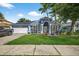 Charming single-story home featuring a well-manicured lawn, blue exterior, and a two-car garage at 9220 Hidden Water Cir, Riverview, FL 33578