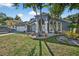 Charming home showcasing the landscaped front yard with beautiful columns and a two-car garage at 9220 Hidden Water Cir, Riverview, FL 33578