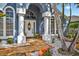 Up-close view of the column-lined front door, surrounded by meticulous landscaping and inviting decor at 9220 Hidden Water Cir, Riverview, FL 33578