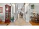 Spacious hallway features tiled floors and arched entryways, connecting different areas with elegant details and charm at 9220 Hidden Water Cir, Riverview, FL 33578